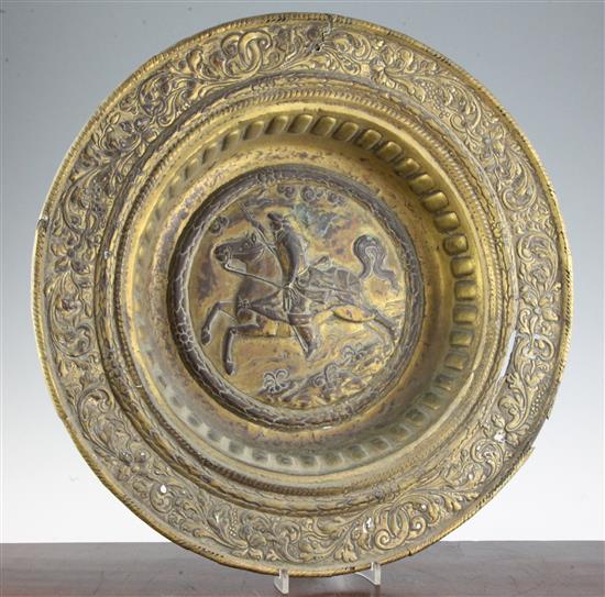 A late 17th century Dutch gilt copper alms dish, 19in.